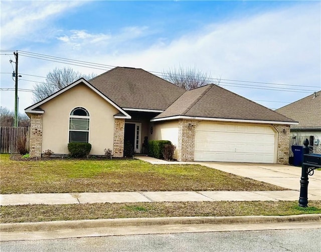 view of front of home with brick siding, driveway, an attached garage, and a front yard