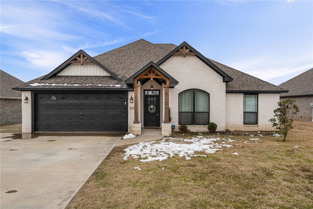 view of front of home featuring a garage and a front lawn