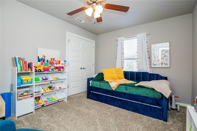 bedroom featuring ceiling fan and carpet