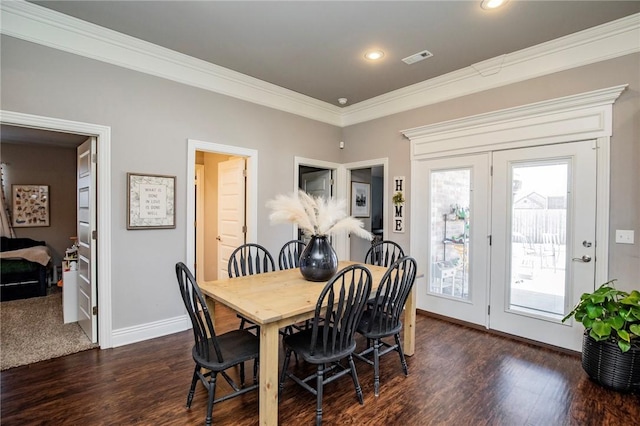 dining space with french doors, crown molding, and dark hardwood / wood-style flooring