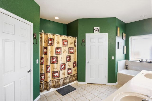 bathroom featuring sink, tile patterned flooring, and a tub to relax in