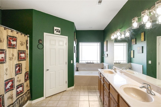 bathroom with a bathing tub, tile patterned floors, and vanity