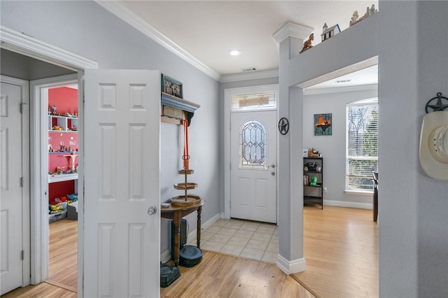 entryway featuring crown molding and light hardwood / wood-style flooring