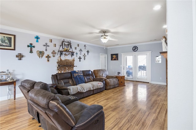 living room with ceiling fan, light hardwood / wood-style floors, and crown molding