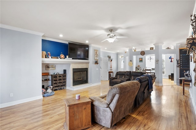 living room with ceiling fan, hardwood / wood-style flooring, and crown molding