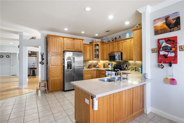 kitchen with kitchen peninsula, stainless steel appliances, light tile patterned floors, and crown molding