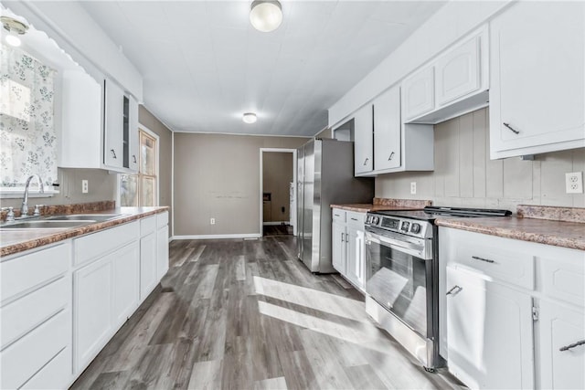 kitchen with sink, stainless steel appliances, dark hardwood / wood-style flooring, and white cabinetry