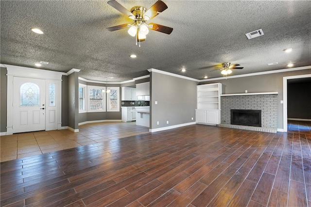 unfurnished living room with crown molding, ceiling fan, and a brick fireplace