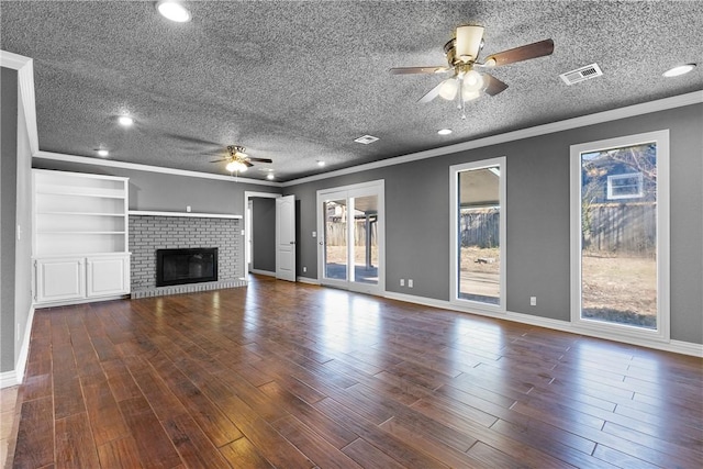 unfurnished living room featuring ceiling fan, dark hardwood / wood-style flooring, crown molding, and a fireplace