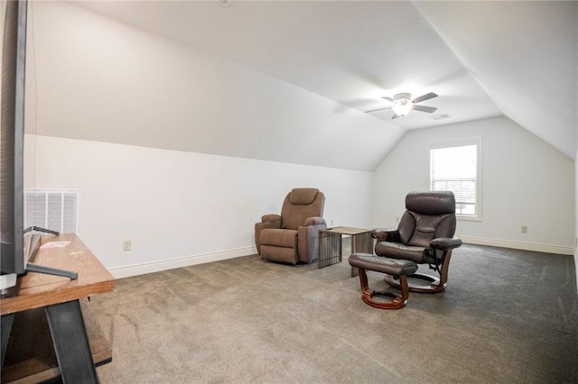 living area featuring lofted ceiling, carpet flooring, and ceiling fan