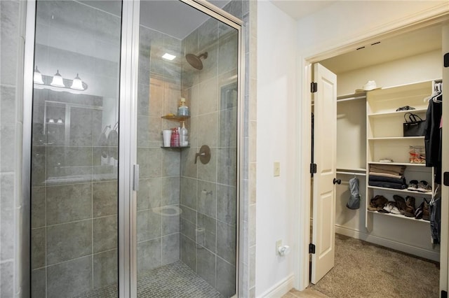 bathroom with a shower with door