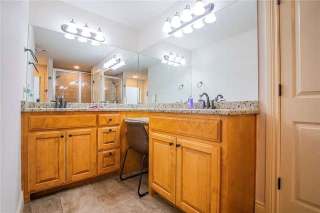 bathroom with vanity and a shower with shower door