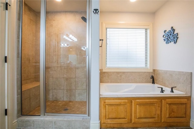 bathroom featuring separate shower and tub