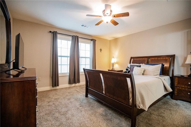 bedroom with ceiling fan and light carpet