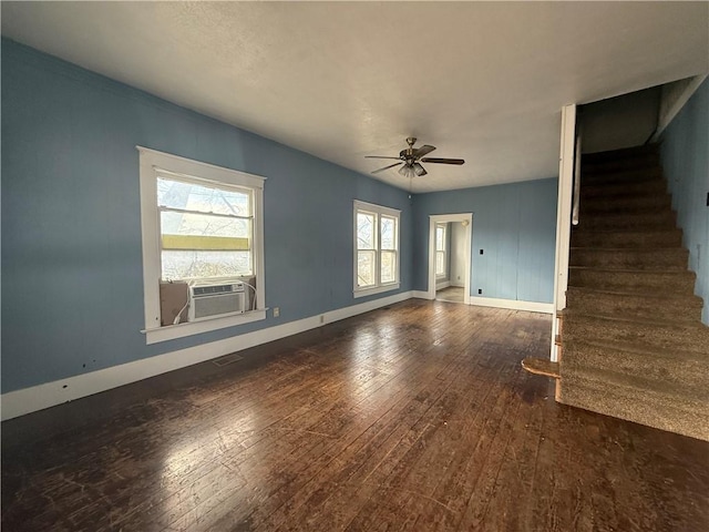 unfurnished living room featuring ceiling fan, cooling unit, and dark wood-type flooring