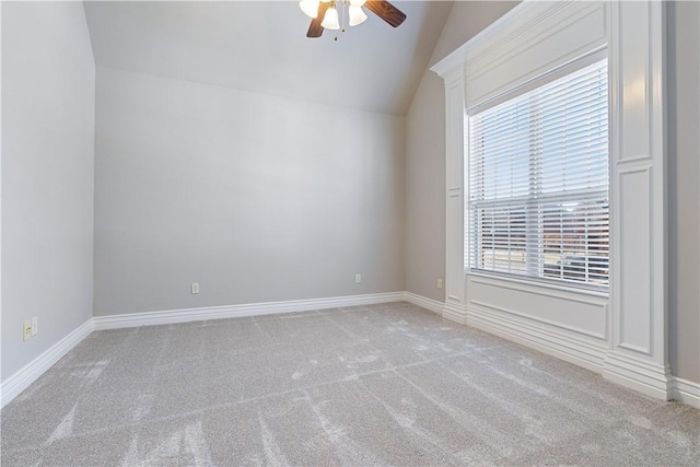 carpeted empty room featuring ceiling fan and lofted ceiling