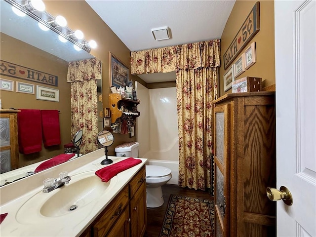 full bathroom with shower / bathtub combination with curtain, vanity, and toilet