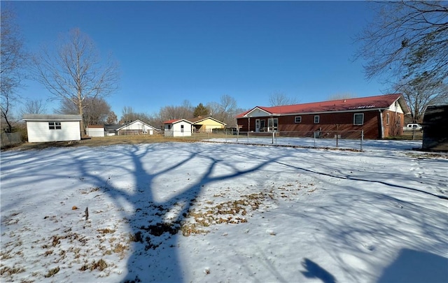 snowy yard with a storage unit