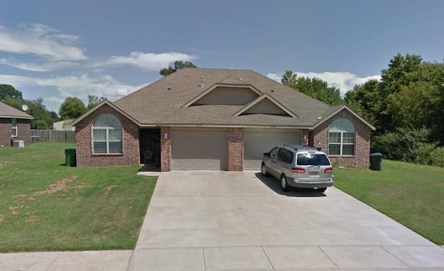 view of front facade with a garage and a front lawn