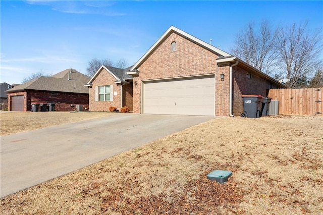 view of front of home featuring a garage and central AC