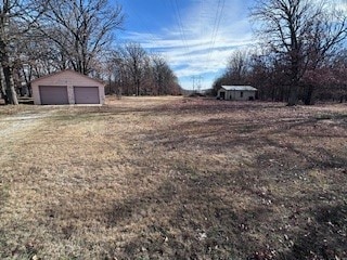 view of yard with an outbuilding and a garage