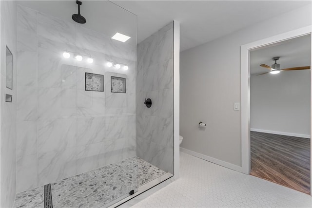 bathroom featuring ceiling fan, tile patterned flooring, and a tile shower