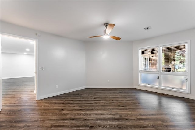 spare room with ceiling fan and dark hardwood / wood-style floors