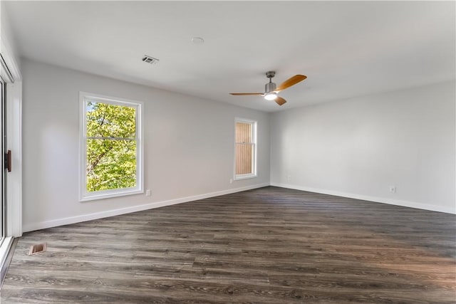 spare room with ceiling fan and dark hardwood / wood-style floors