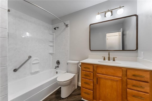 full bathroom featuring toilet, vanity, tiled shower / bath, and hardwood / wood-style flooring