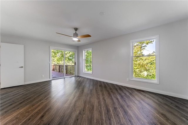 empty room with ceiling fan and dark hardwood / wood-style floors