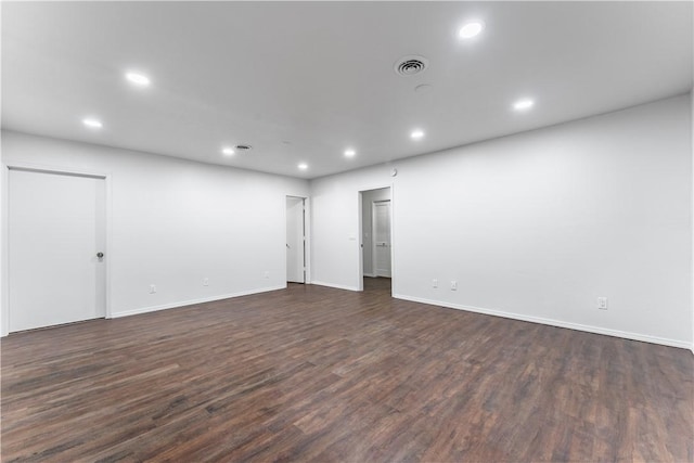 spare room with dark hardwood / wood-style flooring