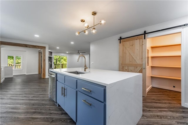 kitchen with dishwasher, sink, blue cabinetry, a center island with sink, and a barn door