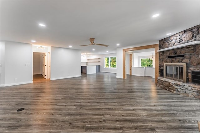 unfurnished living room featuring ceiling fan, dark hardwood / wood-style flooring, and a fireplace