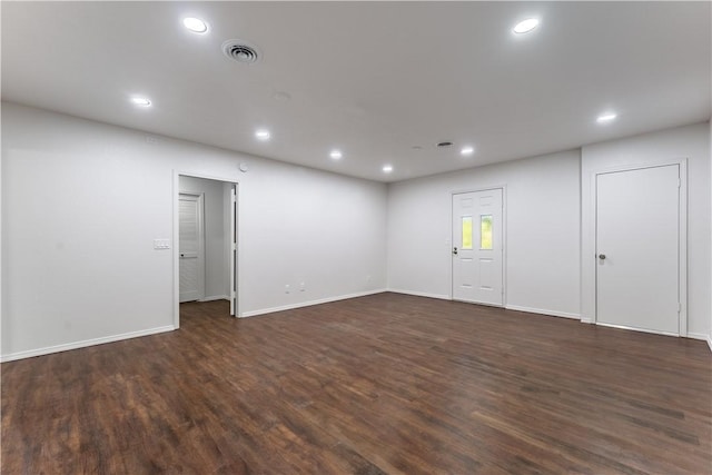 spare room with dark hardwood / wood-style flooring