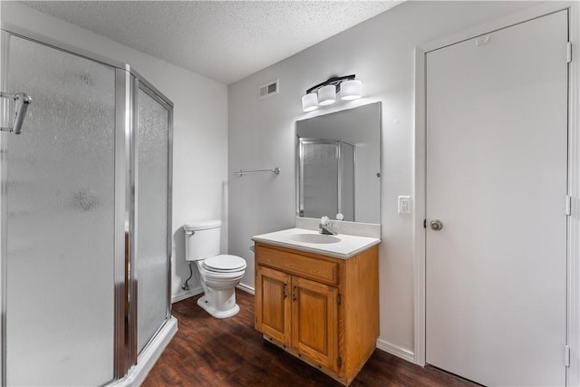 bathroom with walk in shower, hardwood / wood-style floors, and vanity