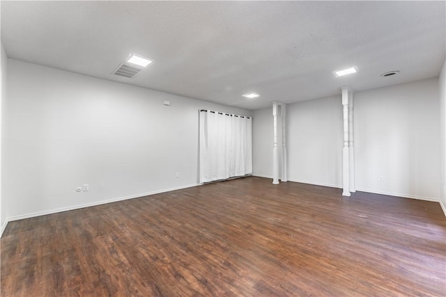 empty room with dark hardwood / wood-style flooring