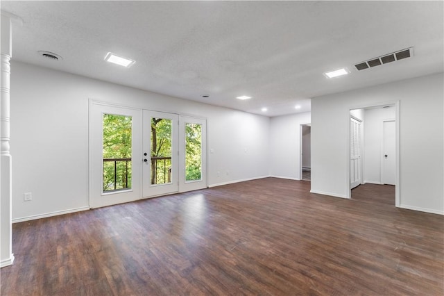 unfurnished room with french doors and dark wood-type flooring