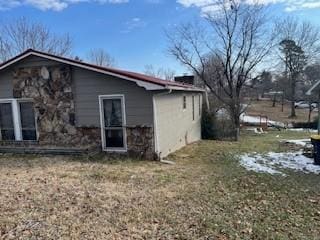 view of side of home featuring a lawn