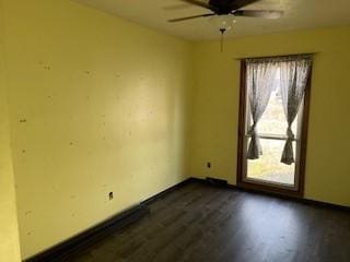 empty room featuring ceiling fan and dark hardwood / wood-style floors