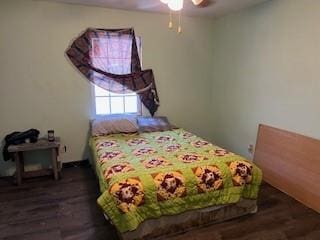 bedroom with ceiling fan and dark wood-type flooring