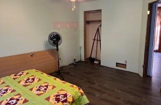 unfurnished bedroom with a closet and dark hardwood / wood-style floors