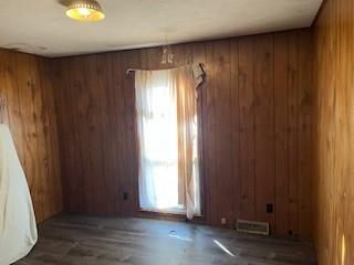 spare room featuring wooden walls