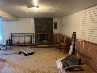 basement with a large fireplace and wooden walls