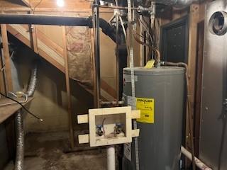 utility room featuring water heater