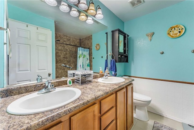 bathroom with vanity, curtained shower, tile patterned floors, and toilet