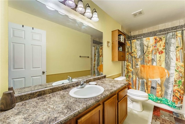 bathroom featuring toilet, vanity, tile patterned floors, and a shower with curtain