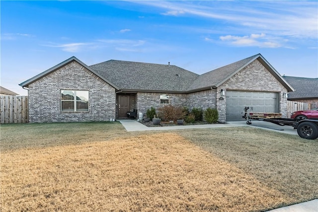 single story home featuring a front lawn and a garage