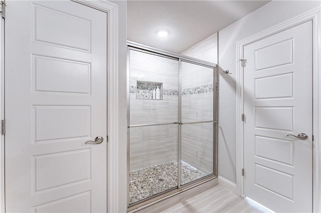 bathroom with a shower with shower door