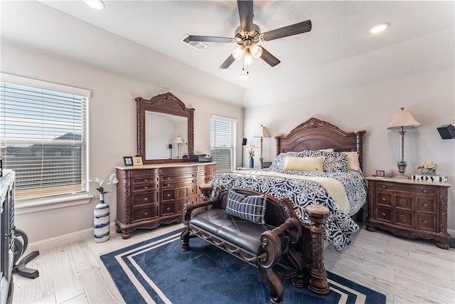 bedroom with ceiling fan, light hardwood / wood-style flooring, multiple windows, and lofted ceiling