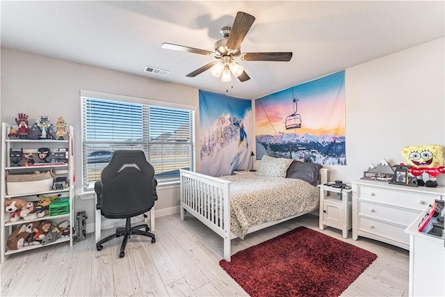 bedroom with ceiling fan and light hardwood / wood-style flooring